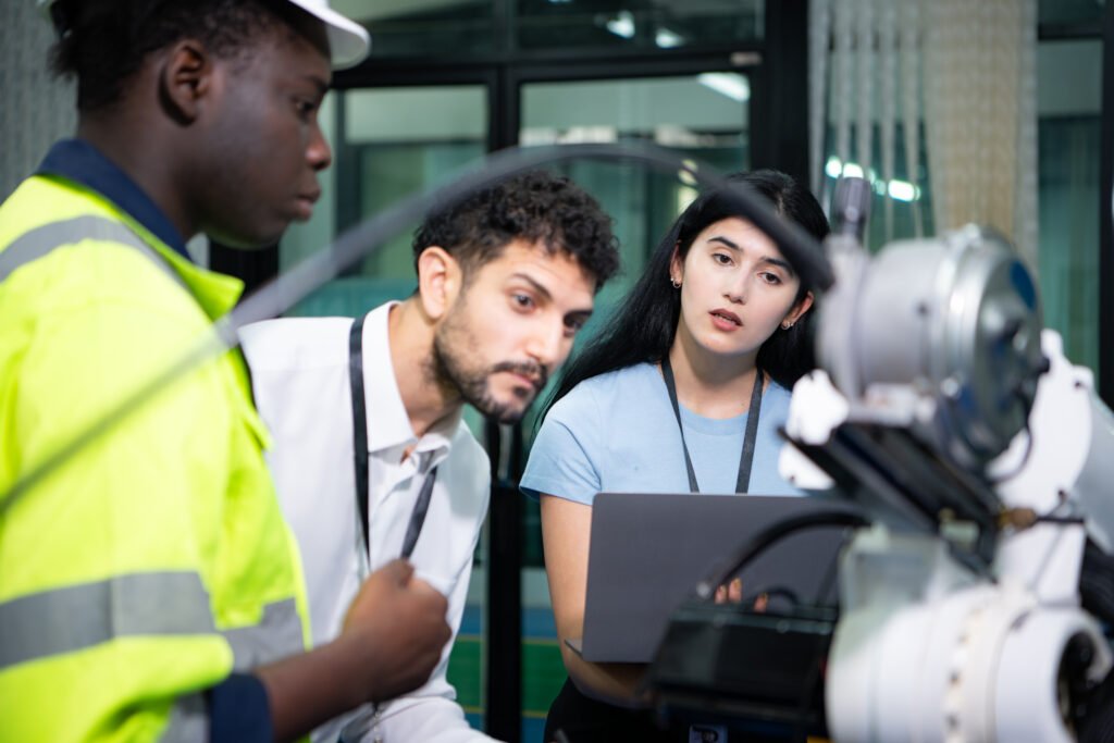 Technicians are introducing industrial hand robots to businessperson of factory industry who will use them in large-scale complex manufacturing operations.